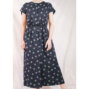 Cap sleeved black dress with abstract polka dots